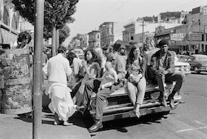 Hippies on car in Haight Ashbury