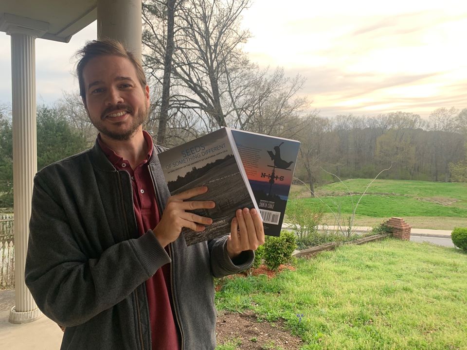 CameronVanderscoff holding Seeds books