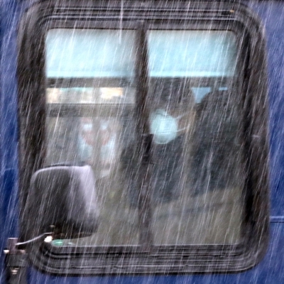 Student on Bus, viewed through rainy window/ Credit Shmuel Thaler