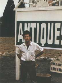 David Sheaffer in front of his antiques shop, 1955-60