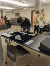 Student view rare book in Special Collections & Archives