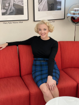 Kelsey sitting on a red couch