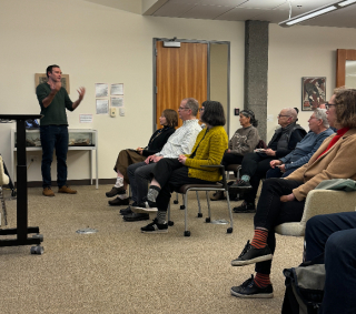 Professor Ben Breen in presenting in front of group of people