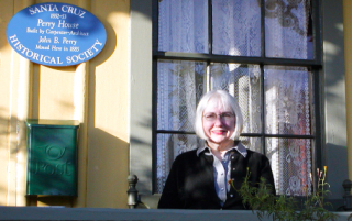 image of Judy Steen on porch of the historical Perry house