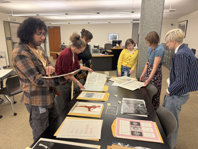 Jacob Sirhan, Melissa Mack, Alaura Hopper, Sam Regal, Meleia Simon-Reynolds, and Kim Kölle Valentine reviewing materials in the Ruth Solomon Papers
