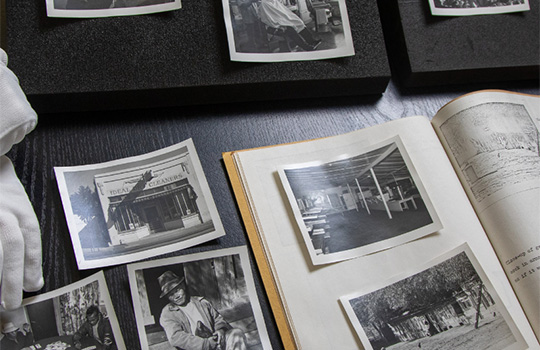 Photo showing several archival photographs being displayed on a table in Special collections